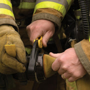 Firefighter using a Res-Q-Rench on a fire hose coupling