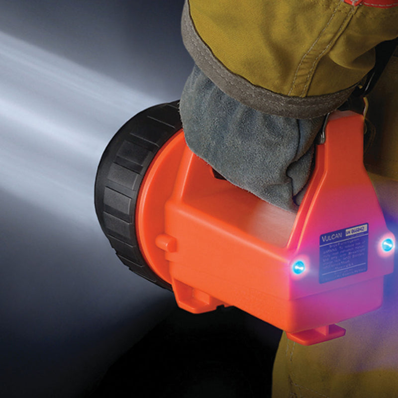 Fire Vulcan LED lantern carried by a gloved firefighter with blue rear taillights illuminated
