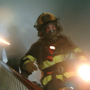 Firefighter wearing a Streamlight Survivor LED light on turnout gear