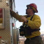 Heavy equipment operator wearing a Strike Team Engineer Fire Shelter Pack